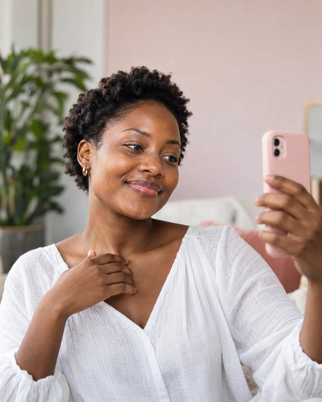 Woman taking a close-up skin selfie in natural daylight